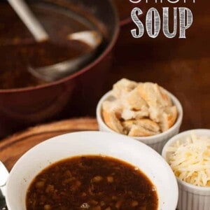 A bowl of French Onion Soup with toasted bread and shredded cheese on the side