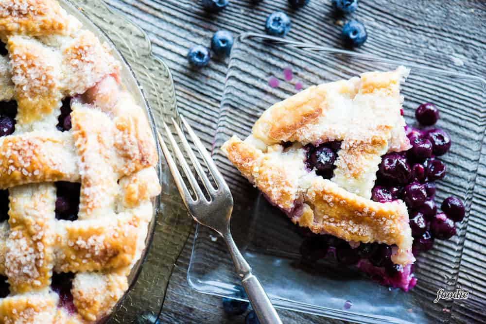 looking down at a piece of fresh blueberry pie on plate