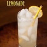 A glass of lemonade with a yellow straw