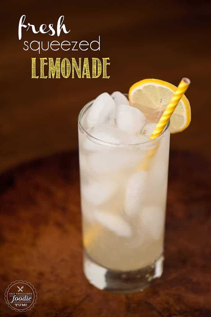 A glass of lemonade with a yellow straw