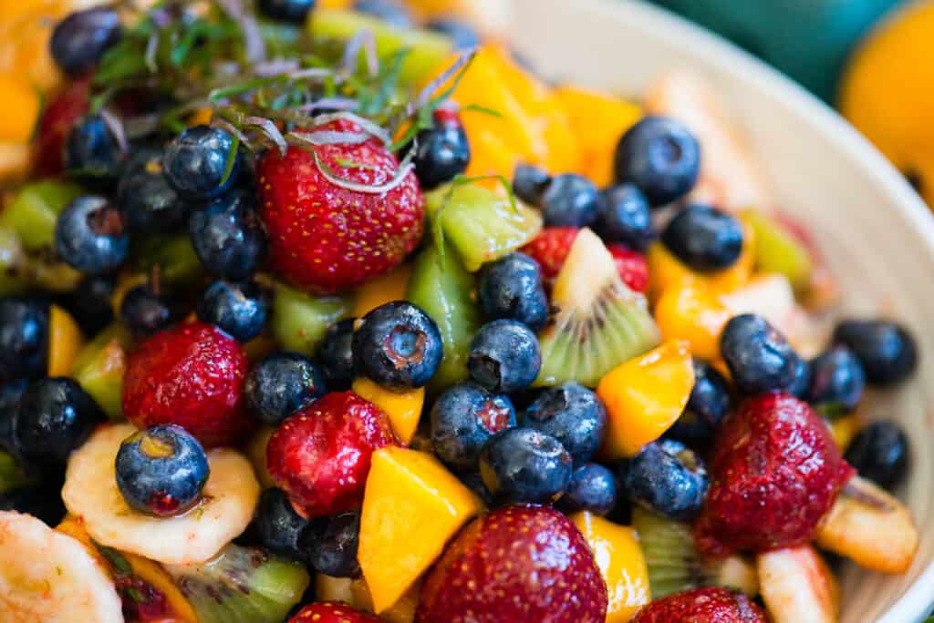 close up of blueberries, kiwi, strawberry, mango fruit salad