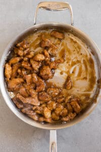 cooked chicken pieces with General Tso's sauce in pan