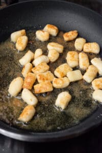 homemade gnocchi in pan of hot oil