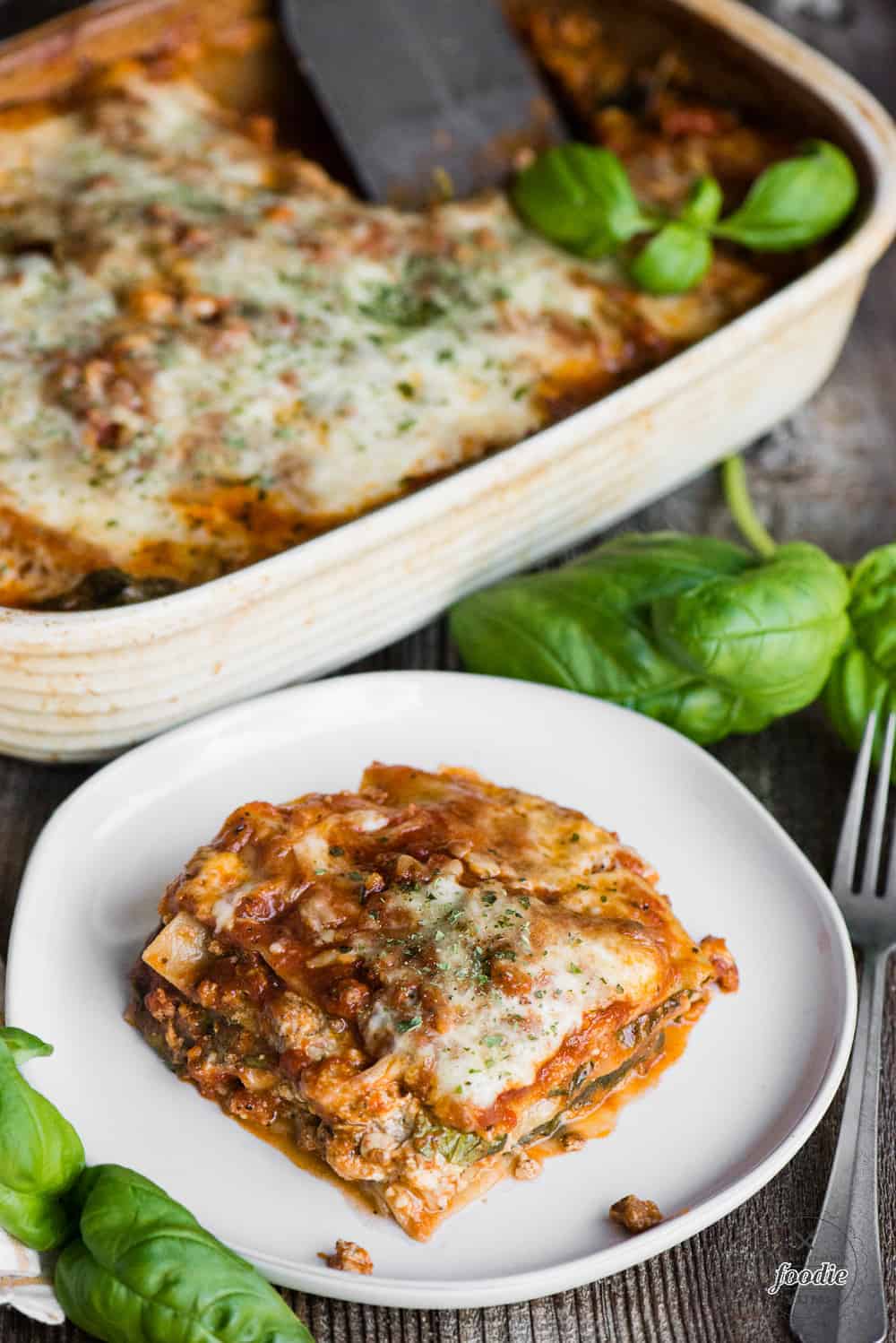 piece of classic lasagna on round white plate