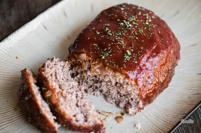 classic meatloaf recipe with ketchup topping on serving dish