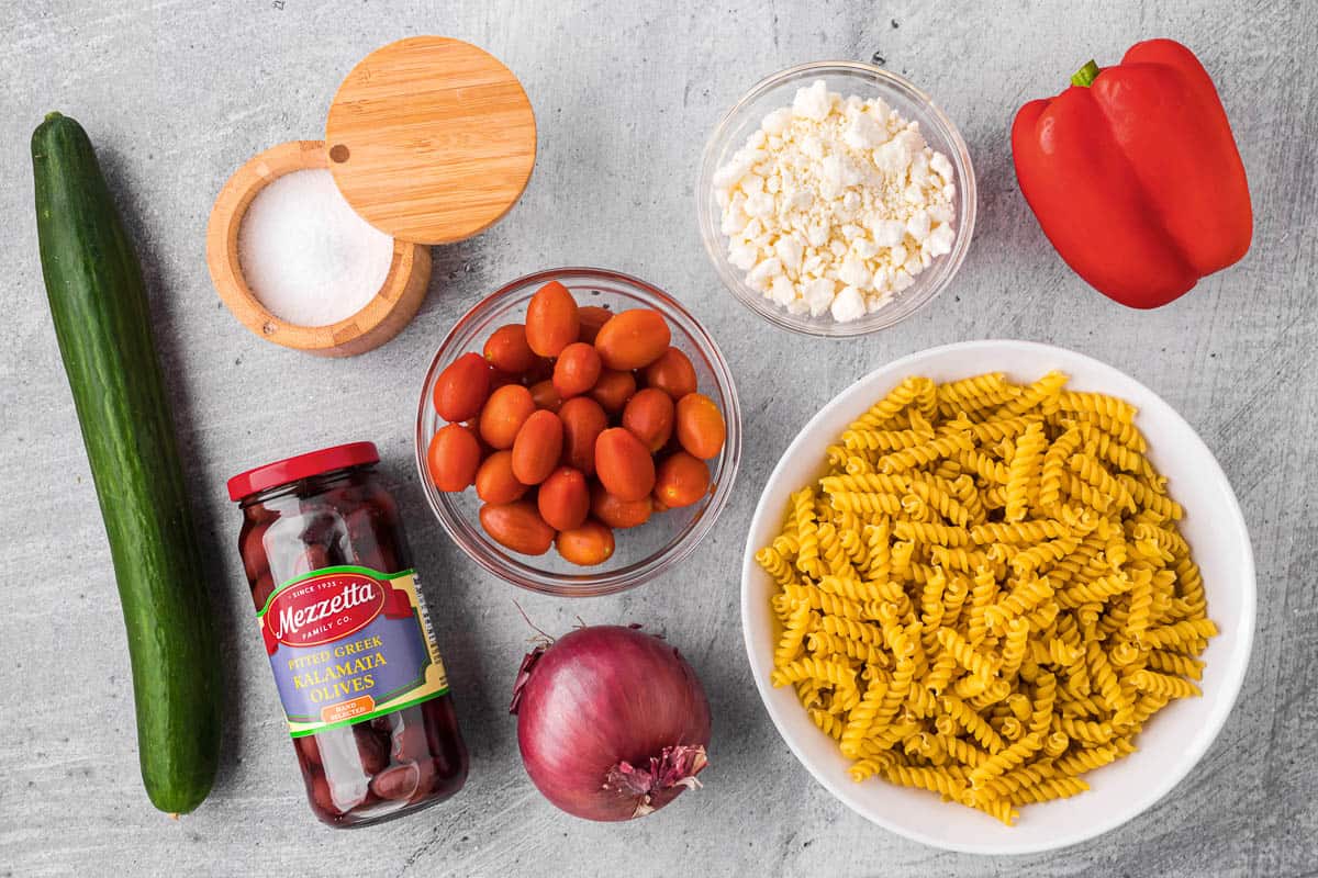 Ingredients needed to make Greek pasta salad.
