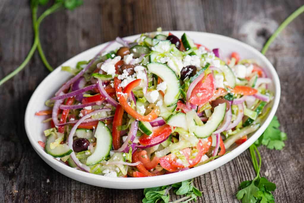 homemade Greek Salad in white oval dish