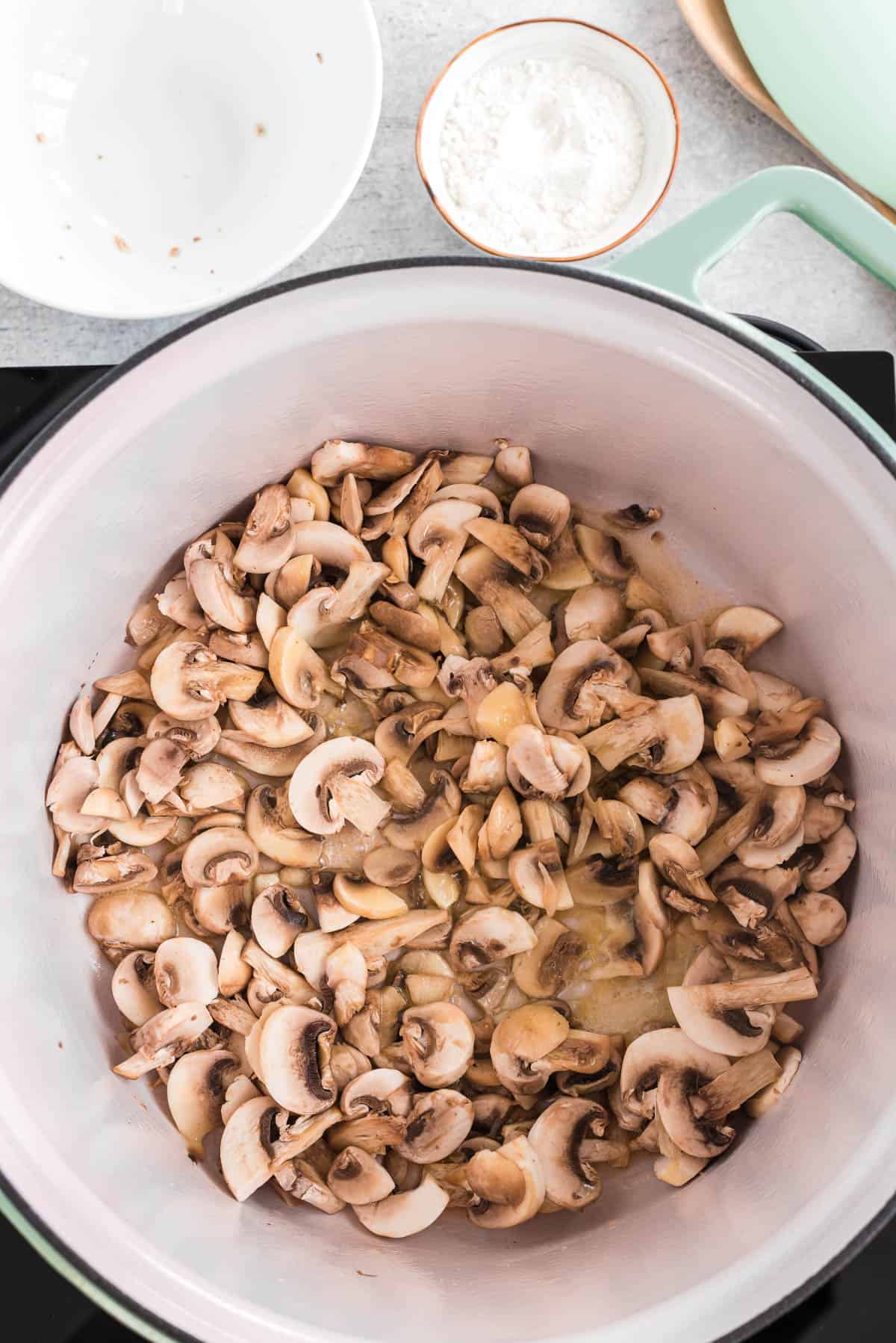 cooking sliced mushrooms in melted butter.