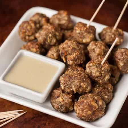 Four ingredient Green Chile Cheddar Meatballs are easy to make, taste fantastic with white cheddar cheese sauce, & can be eaten as a main dish or appetizer.