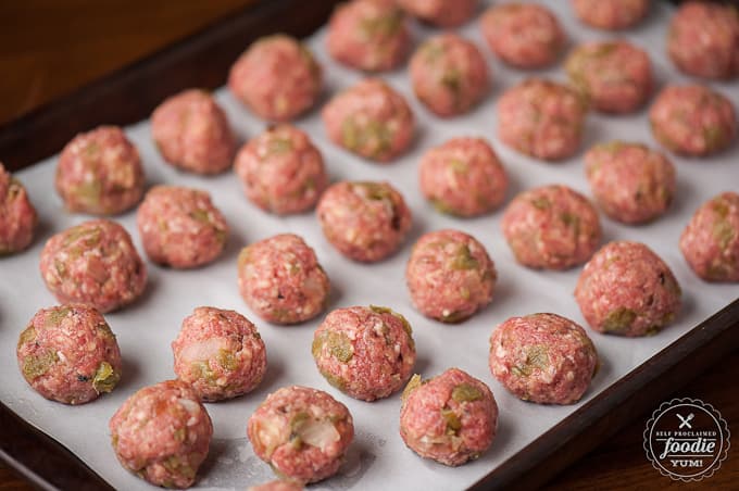 Green Chile Cheddar Meatballs on baking sheet before they are baked