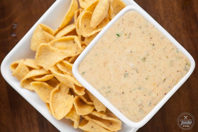 square white dish of cheese sauce with chips