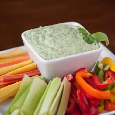 This guilt-free creamy and healthy Green Goddess Dip with just a hint of heat is packed full of veggies and herbs and makes the perfect summer snack.
