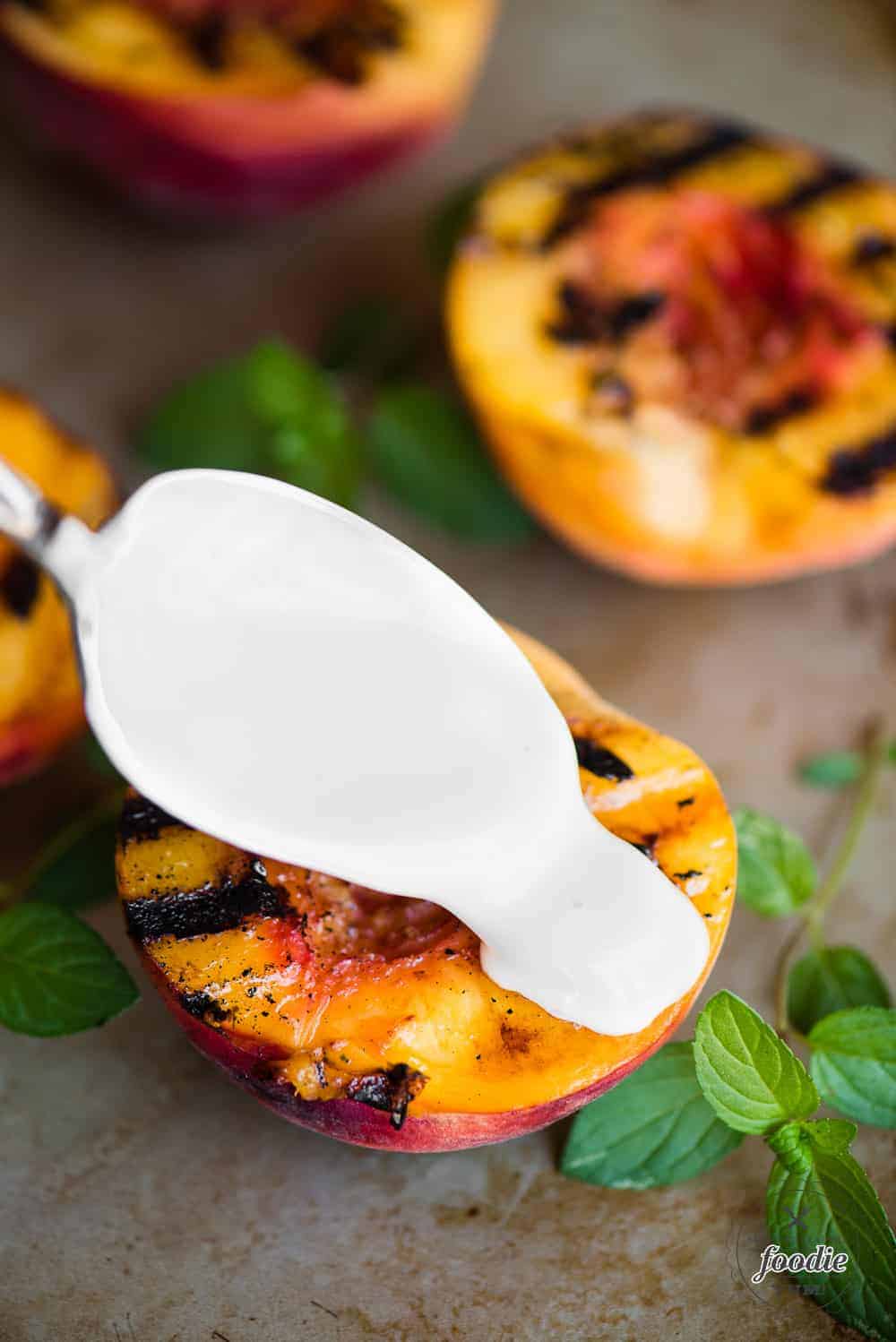 grilled fresh peaches with a spoon of sweet cream