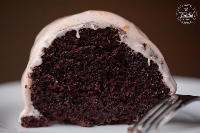 Slice of chocolate bundt cake topped with frosting