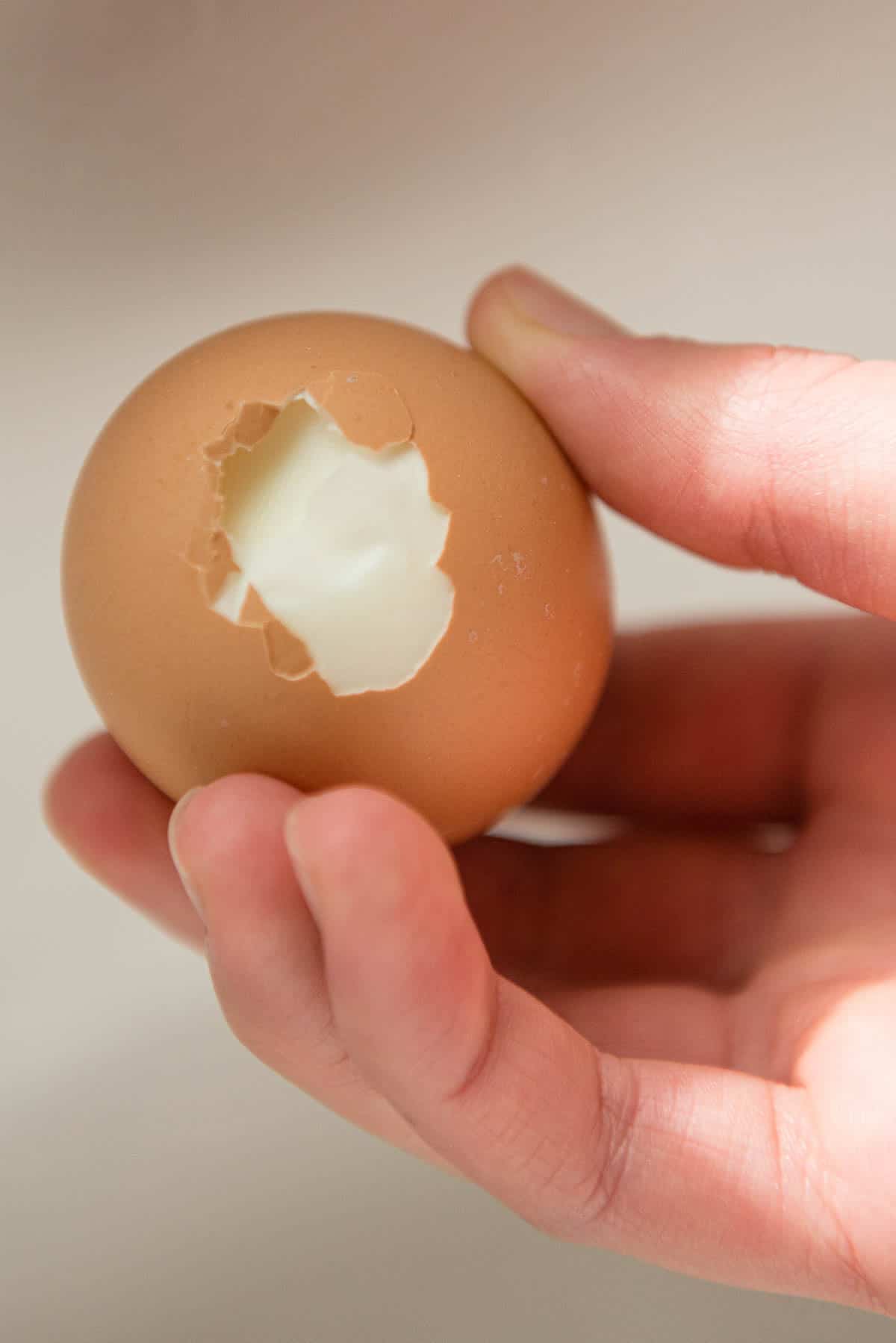 bottom of hard boiled egg with part of shell removed.