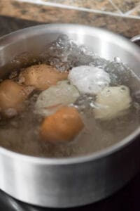 boiling eggs on stovetop.