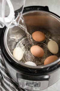 adding water to Instant Pot to make hard boiled eggs.