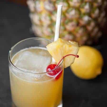 This tart Hawaiian Stone Sour made with whiskey and pineapple juice will make your mouth pucker while you daydream about relaxing on a tropical beach.