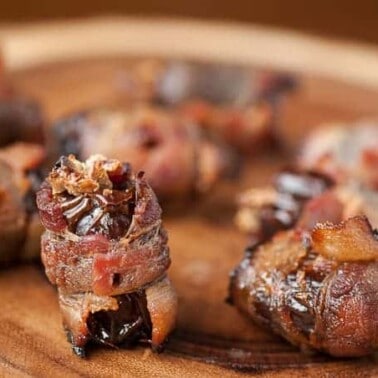 These tasty Holiday Bacon Wrapped Dates are stuffed with holiday goodies like dried cranberries and candied pecans to make the perfect holiday appetizer.