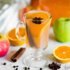 glass of Homemade apple cider with orange slice
