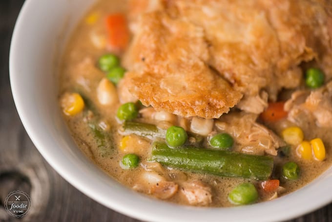 a close up photo of chicken with crust and vegetables