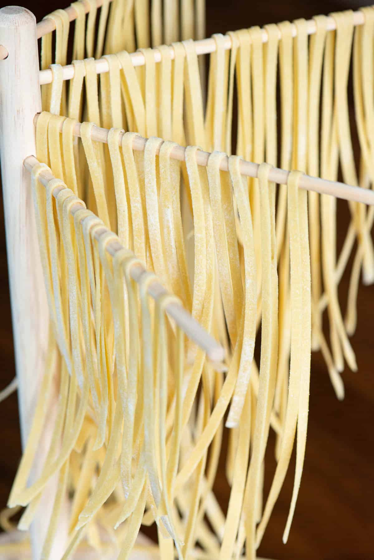 Step By Step Manual Process Of Making Italian Pasta Fettuccine Home Pasta  With Pasta Maker Flour Semola Di Grano Duro Eggs Tomatoes Basil Lie On A  Wooden Table For The Recipe Stock