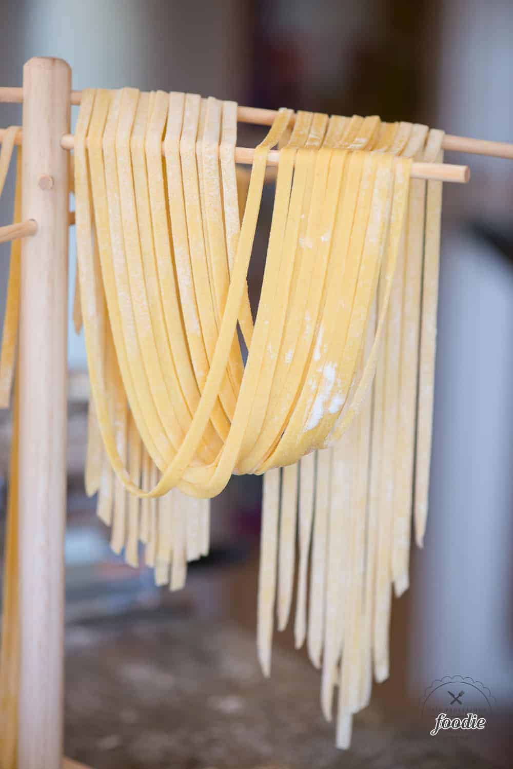 Homemade pasta hanging on a rack