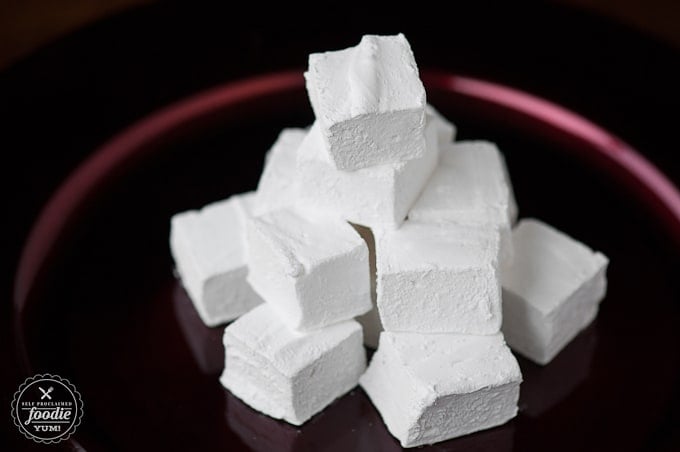 a stack of homemade peppermint marshmallows on red platter
