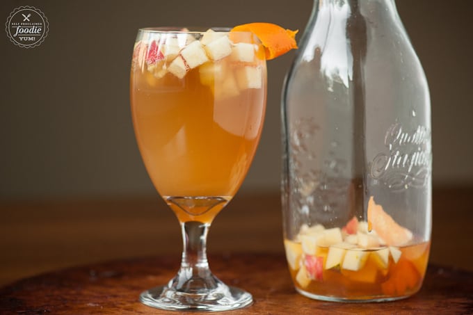 glass of apple sangria with chopped fruit