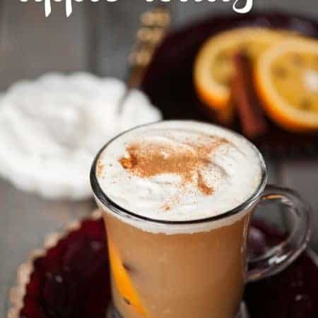 Warm your belly this fall with a Hot Apple Toddy made in your slow cooker with apple cider, clove studded oranges, whiskey, and real whipped cream.