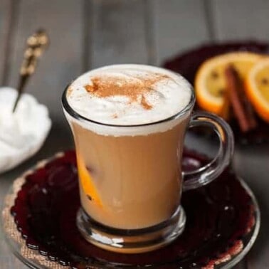 Warm your belly this fall with a Hot Apple Toddy made in your slow cooker with apple cider, clove studded oranges, whiskey, and real whipped cream.
