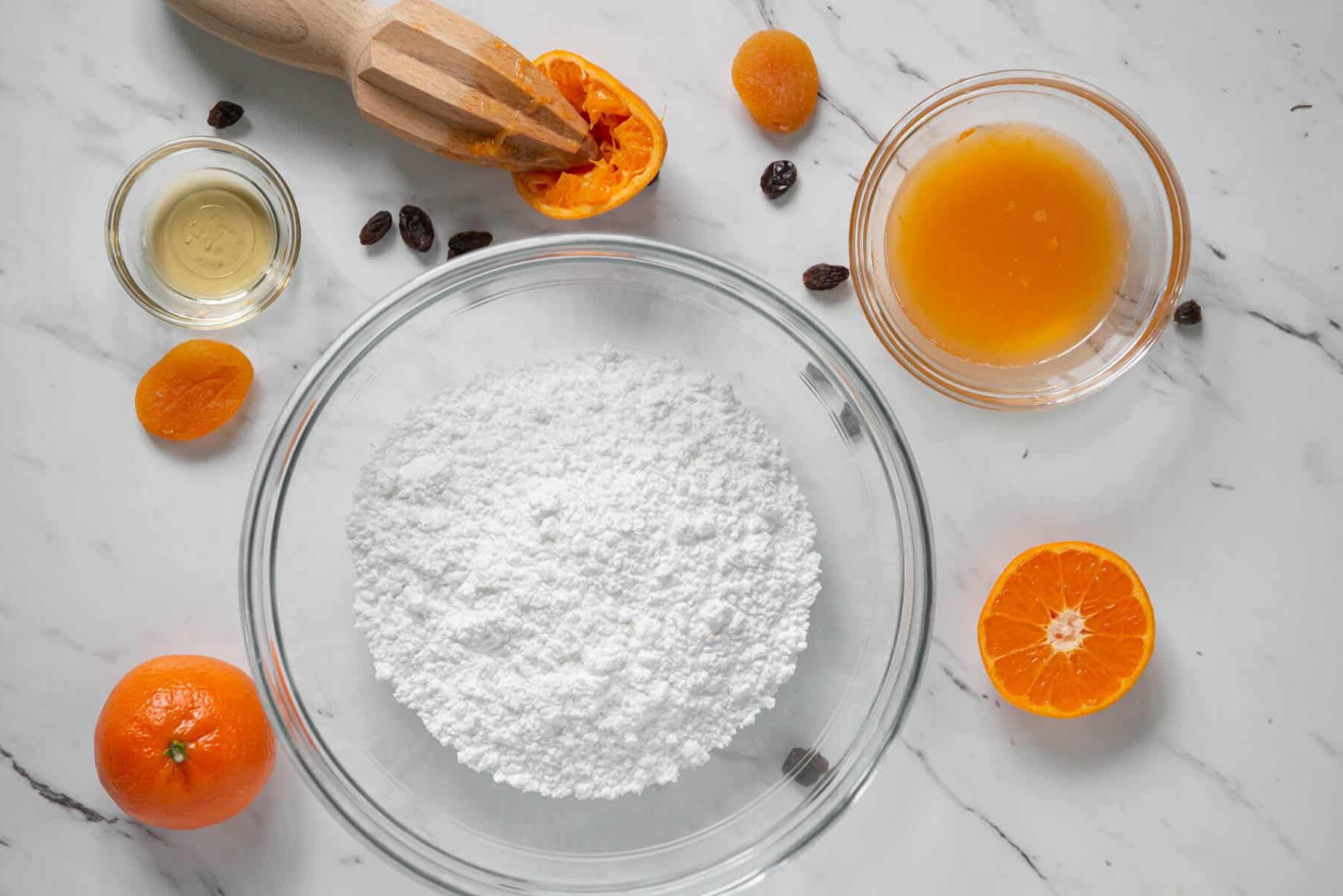 powdered sugar in bowl with mandarin juice.