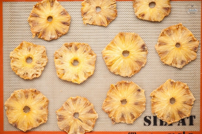 homemade dried pineapple rings on baking sheet