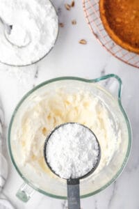 adding powdered sugar to cream cheese