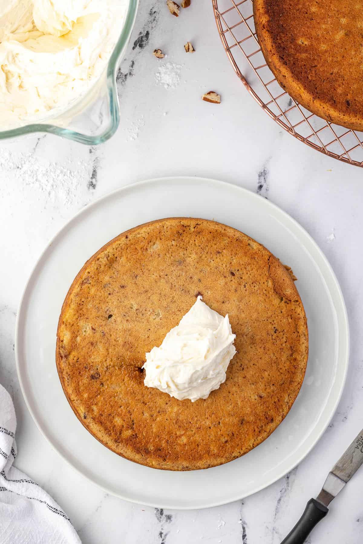 adding frosting to cake