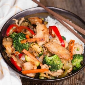 hunan chicken stir fry in bowl over rice