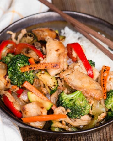 hunan chicken stir fry in bowl over rice