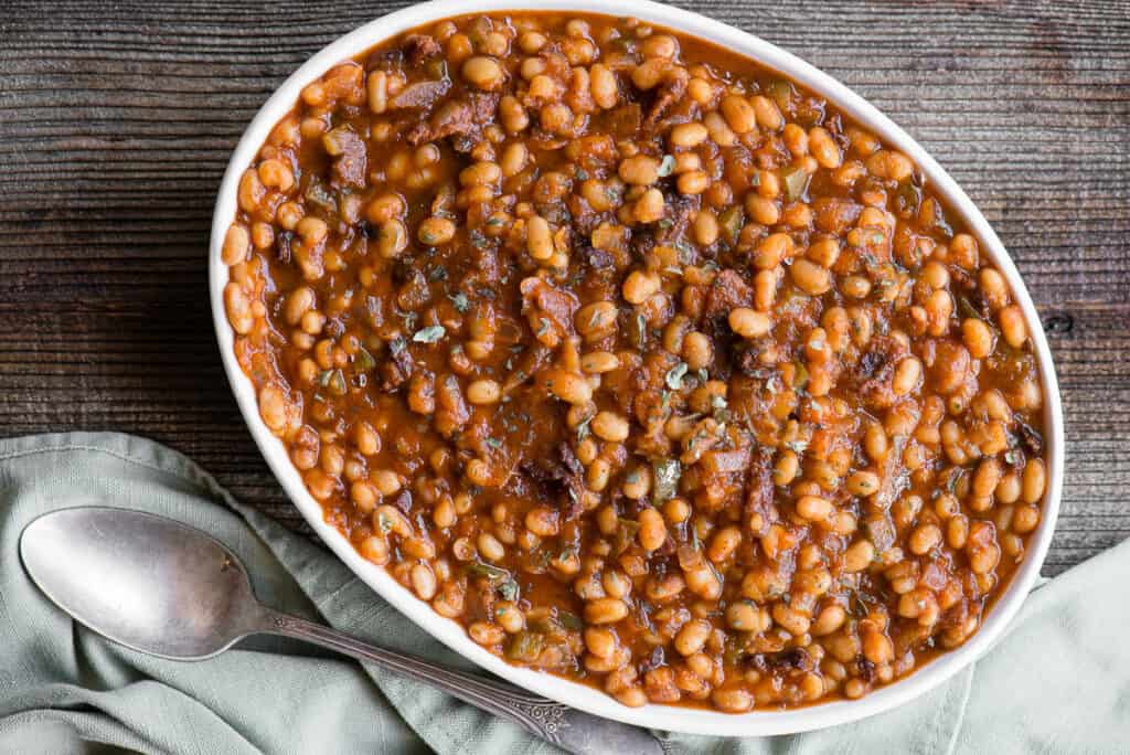 oval dish of bacon baked beans