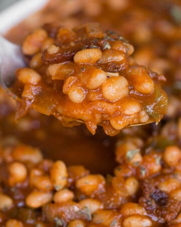 spoonful of homemade baked beans with bacon
