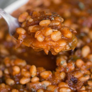 spoonful of homemade baked beans with bacon