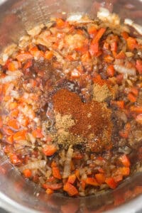 spices added to sautéed onion and red bell pepper