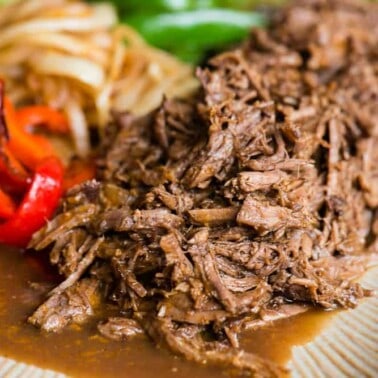 tender shredded beef with peppers and onions made in the instant pot