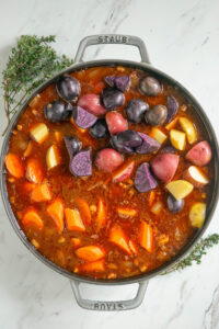 Pot of Irish stew with colorful potatoes.