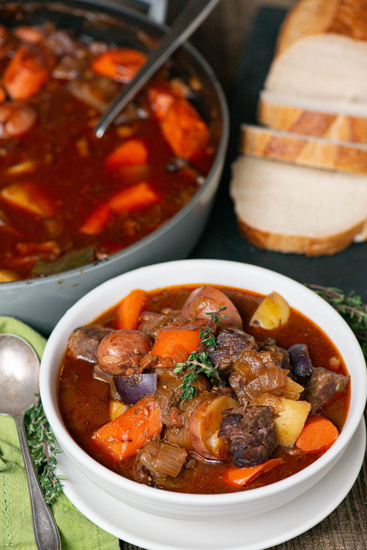 Bowl of Irish stew with sliced bread on side.