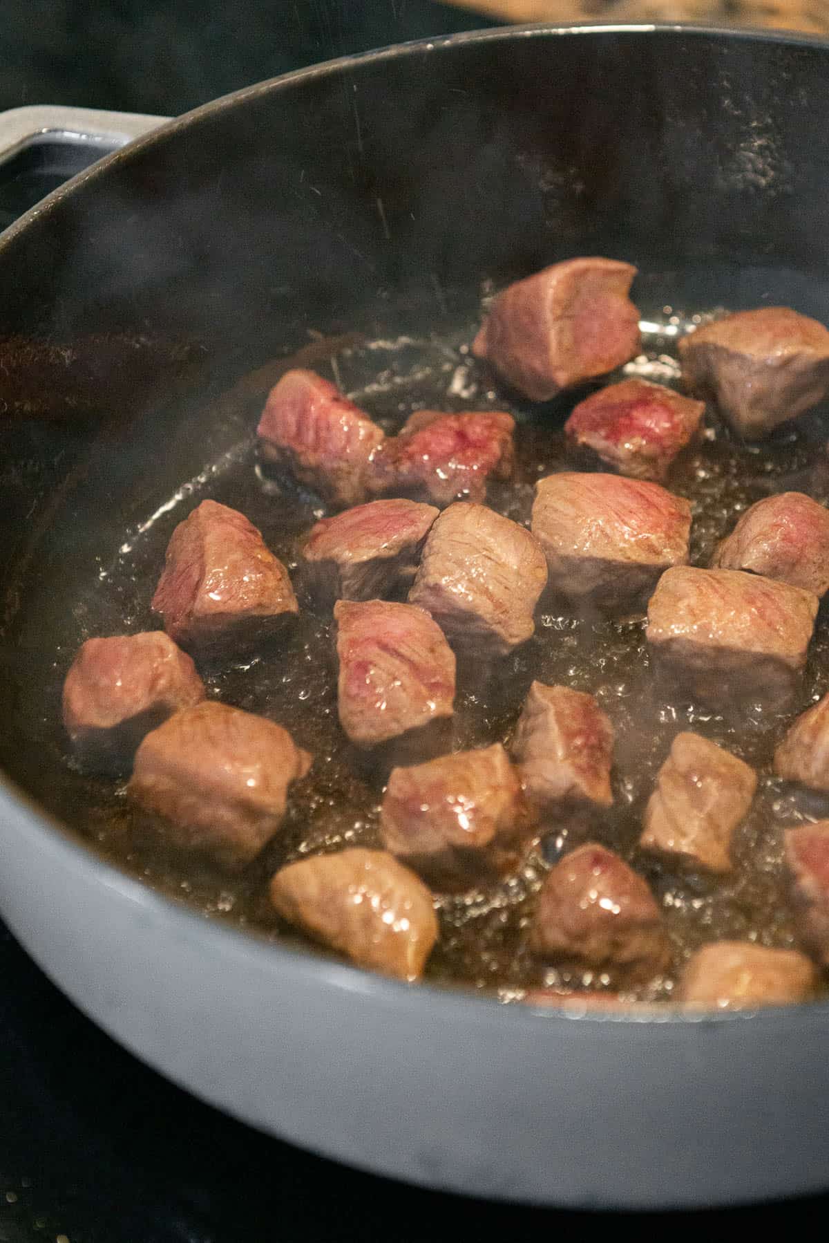 searing stew meat in oil.