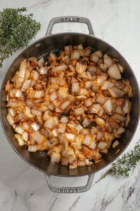 sauteed onions and bacon in pan.