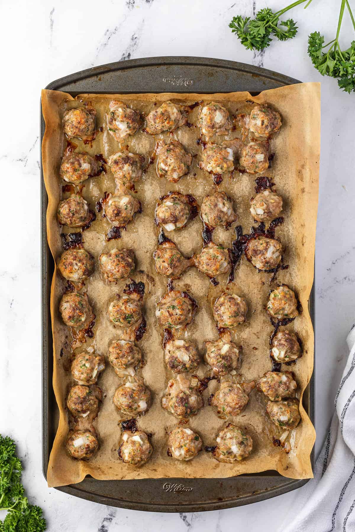 baking sheet full of cooked meatballs.