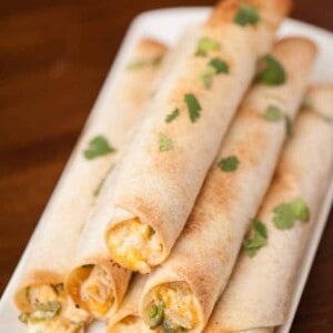 Feed a crowd at any game time party with these incredibly delicious and easy to make Jalapeno Popper Chicken Flautas finger foods.