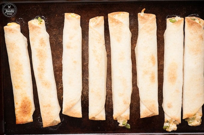 baked flautas on baking sheet