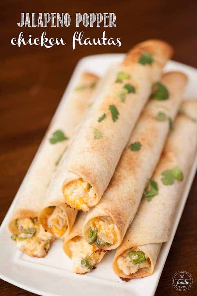 platter with stack of baked chicken flautas